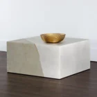 Square concrete coffee table with angular crack-inspired detail and softly weathered stone texture.