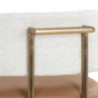 A modern Larissa Stool featuring a warm caramel leather seat, curved white boucle backrest, and slim brushed brass metal frame.