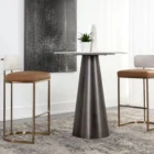 A modern Larissa Stool featuring a warm caramel leather seat, curved white boucle backrest, and slim brushed brass metal frame.