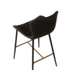 Diamond-stitched black leather seat upholstery, with quilted seat and brass footrest.