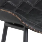 Diamond-stitched black leather seat upholstery, with quilted seat and brass footrest.