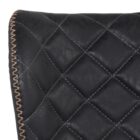 Diamond-stitched black leather seat upholstery, with quilted seat and brass footrest.
