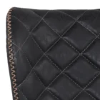 Diamond-stitched black leather seat upholstery, with quilted seat and brass footrest.