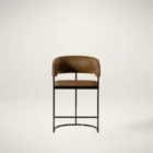 Modern counter stool featuring a curved saddle leather backrest, cushioned seat, and sleek black metal frame with an arched footrest.