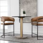 Modern counter stool featuring a curved saddle leather backrest, cushioned seat, and sleek black metal frame with an arched footrest.