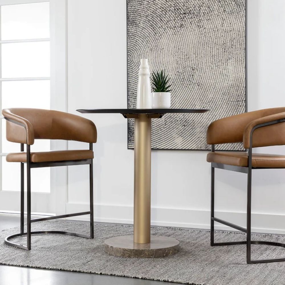 Modern counter stool featuring a curved saddle leather backrest, cushioned seat, and sleek black metal frame with an arched footrest.