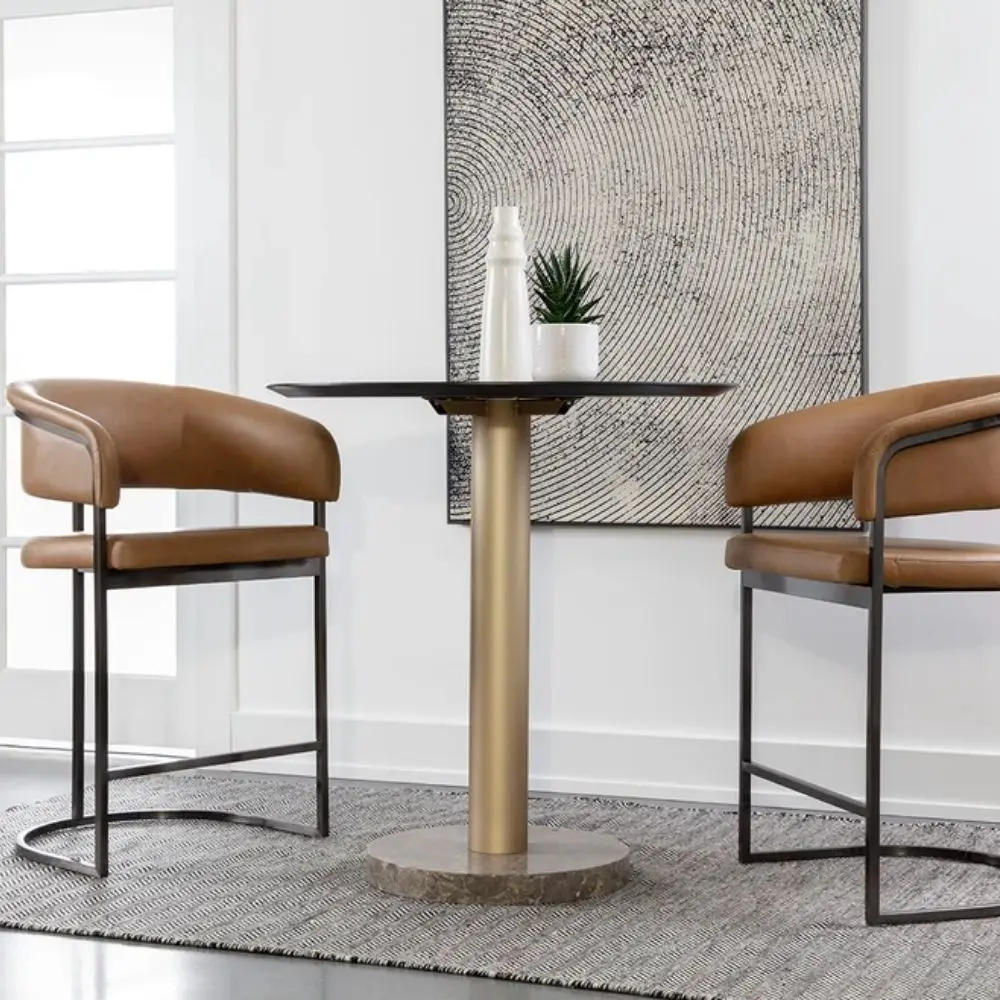 Modern counter stool featuring a curved saddle leather backrest, cushioned seat, and sleek black metal frame with an arched footrest.