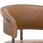 Modern counter stool featuring a curved saddle leather backrest, cushioned seat, and sleek black metal frame with an arched footrest.
