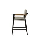 Meadow Counter Stool highlighting the curved backrest, textured upholstery, and sleek black frame with integrated wooden armrests.
