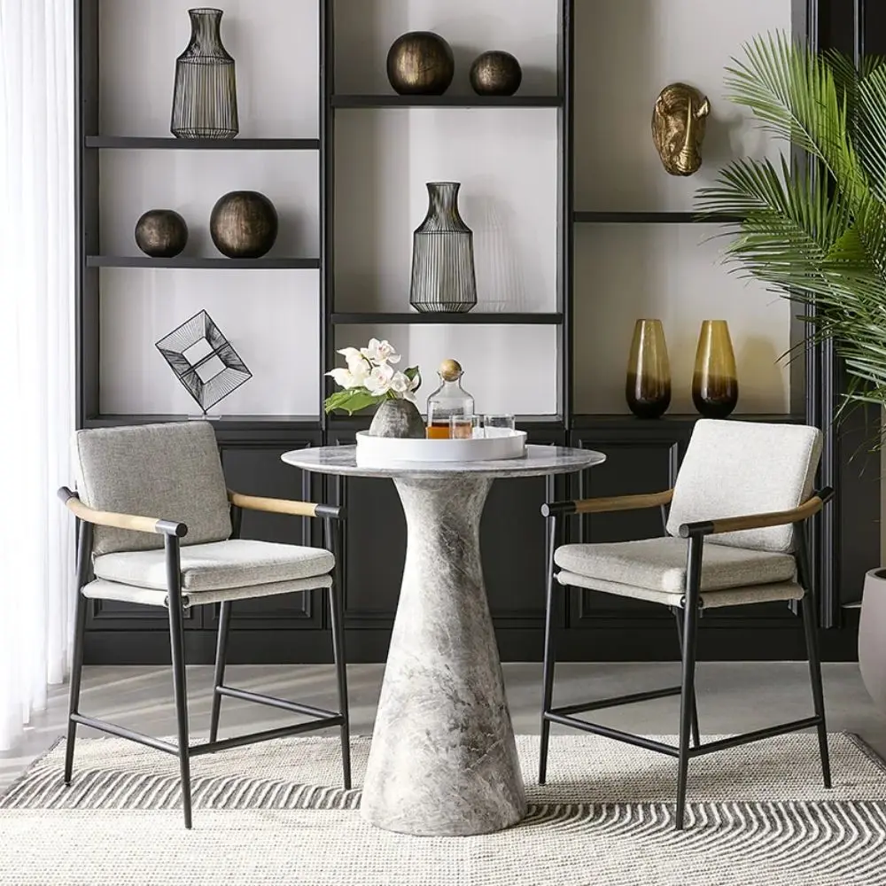 Meadow Counter Stool highlighting the curved backrest, textured upholstery, and sleek black frame with integrated wooden armrests.