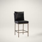Paige Counter Stool featuring a black faux leather upholstered seat and loose-style back cushion, set on a brushed metal frame with footrest