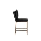 Paige Counter Stool featuring a black faux leather upholstered seat and loose-style back cushion, set on a brushed metal frame with footrest