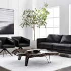 Live-edge sculptural coffee table crafted from dark natural teak wood with organic curves and black angular legs.