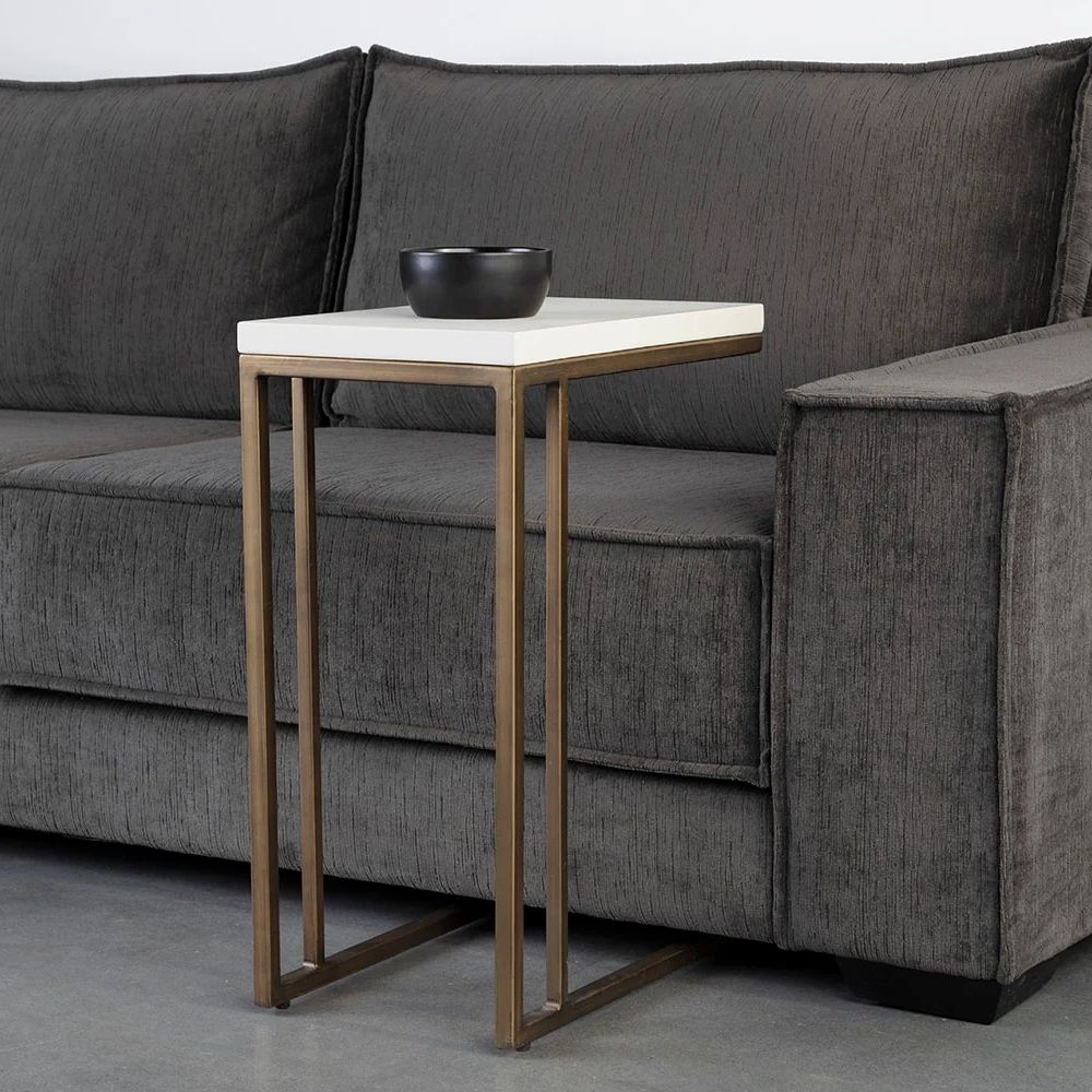 Modern white C-shaped end table with a thin metal base in a bronze finish and a sleek white top.