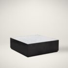 Modern square coffee table with a sleek black base and white marble top, featuring minimalist cube styling.