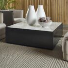 Modern square coffee table with a sleek black base and white marble top, featuring minimalist cube styling.