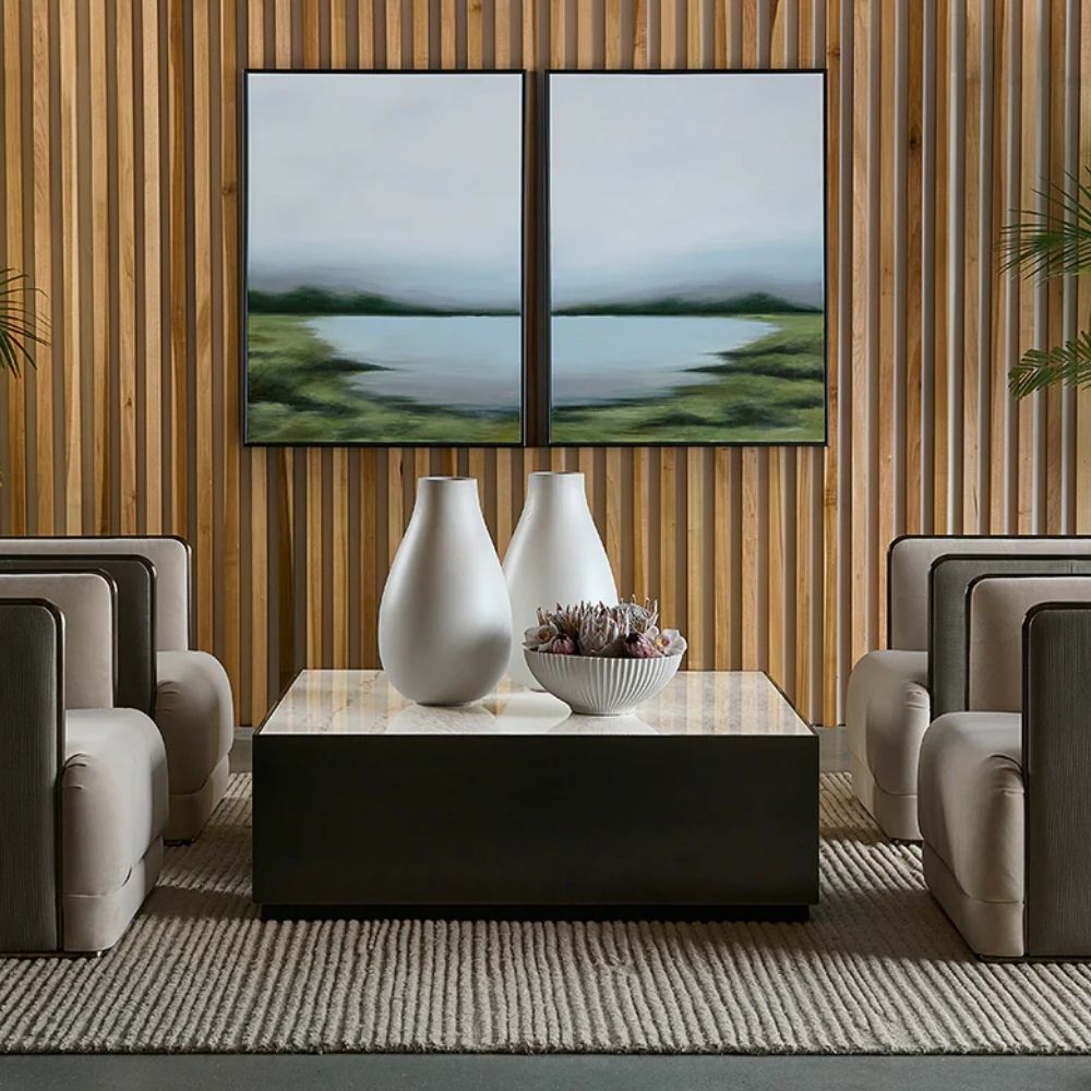 Modern square coffee table with a sleek black base and white marble top, featuring minimalist cube styling.
