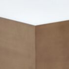 Square coffee table with a white top, warm brass-toned sides, and a low black plinth base.