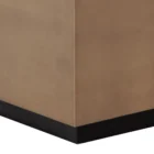 Square coffee table with a white top, warm brass-toned sides, and a low black plinth base.