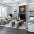 Square coffee table with a white top, warm brass-toned sides, and a low black plinth base.