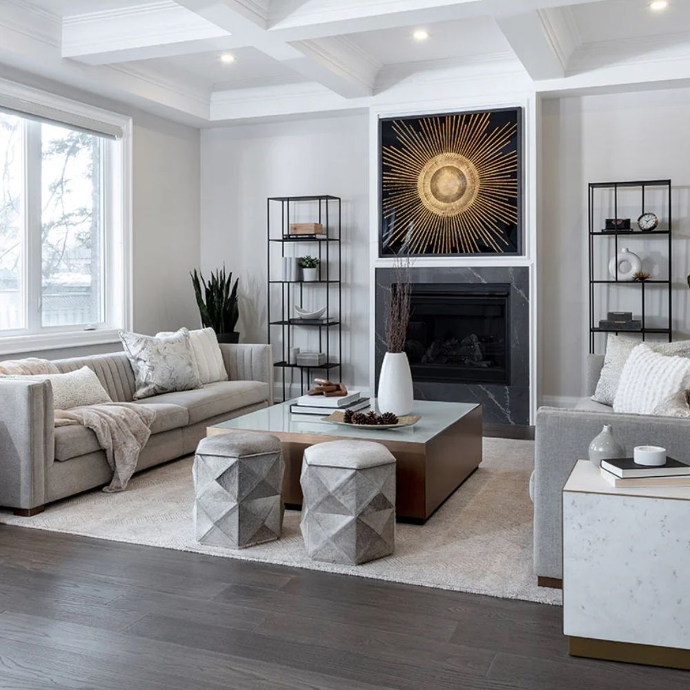 Square coffee table with a white top, warm brass-toned sides, and a low black plinth base.