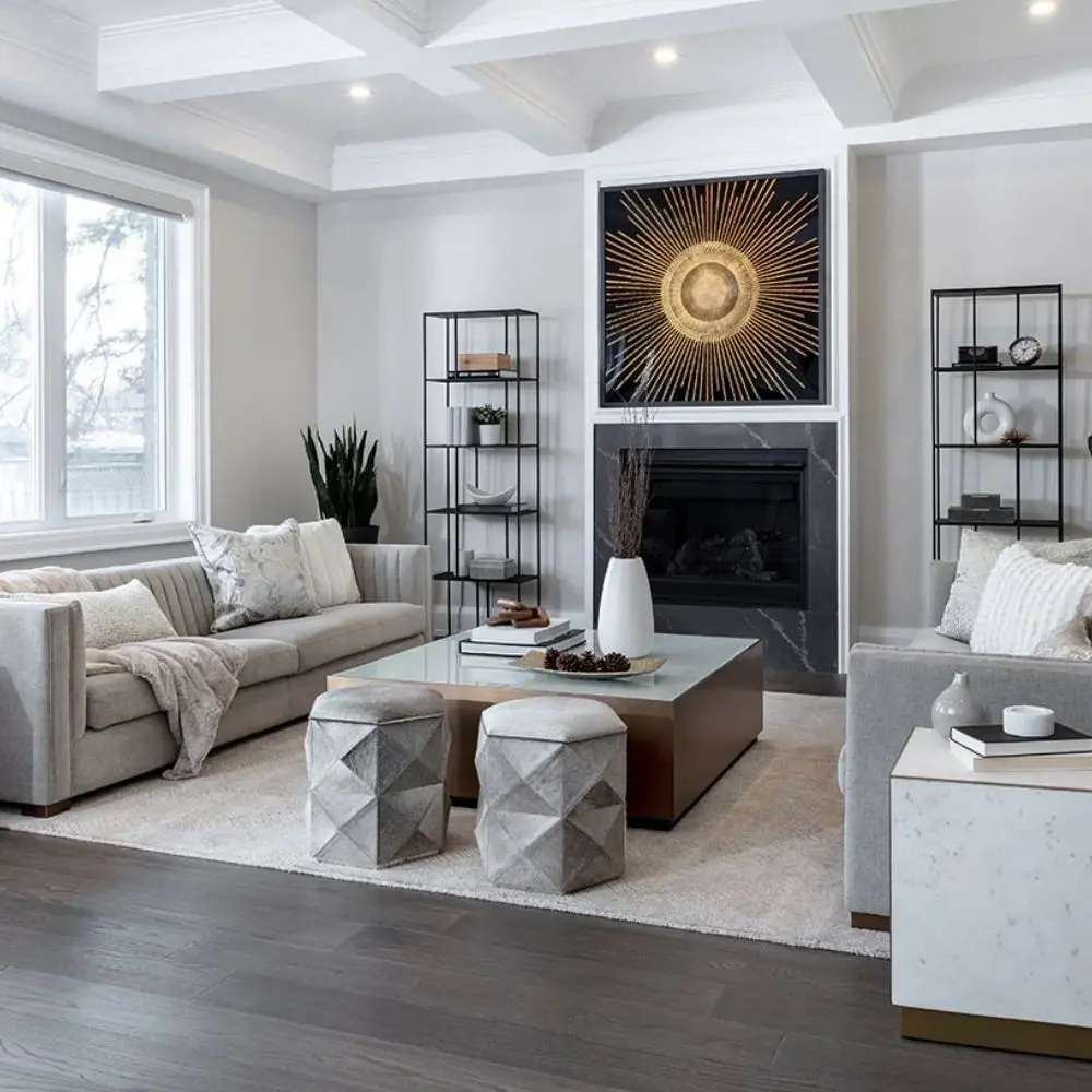 Square coffee table with a white top, warm brass-toned sides, and a low black plinth base.