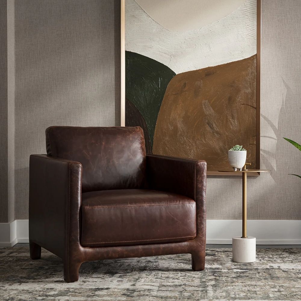 Contemporary end table with a slim brass-finished stem, round brass top with a handle, and white marble cylinder base.