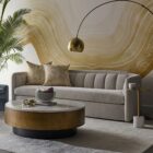 Contemporary end table with a slim brass-finished stem, round brass top with a handle, and white marble cylinder base.