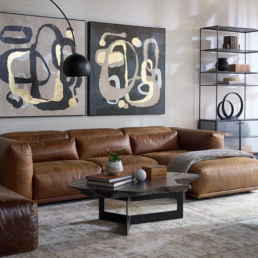 Live-edge wood coffee table with sculptural, raw edges and a black geometric metal base.