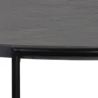 Round black coffee table with slim metal frame, lower glass shelf, and gold-dipped leg tips.