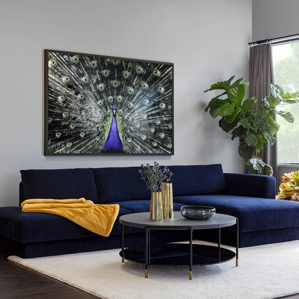 Round black coffee table with slim metal frame, lower glass shelf, and gold-dipped leg tips.