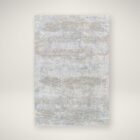 Brunswick Machine Woven Rug in soft greys, creams, and beige tones with a distressed abstract pattern.
