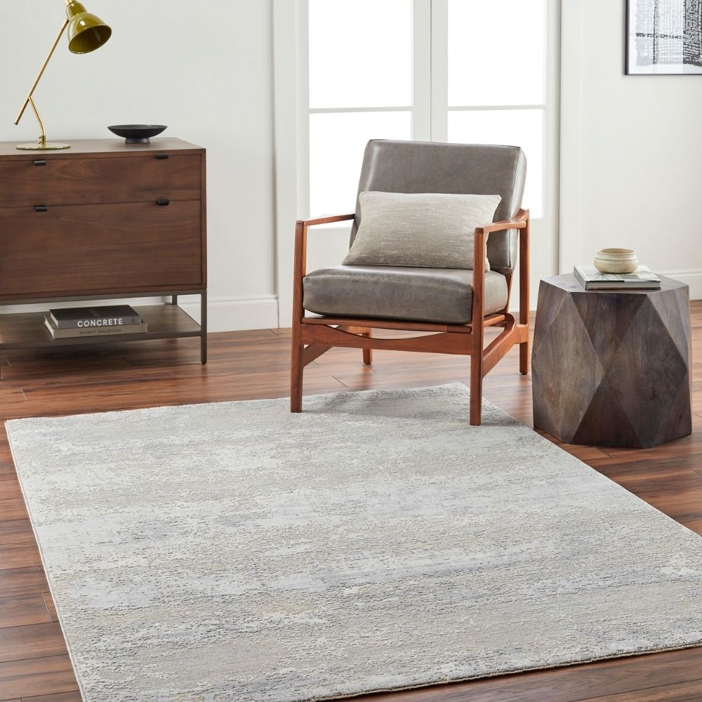 Brunswick Machine Woven Rug in soft greys, creams, and beige tones with a distressed abstract pattern.