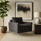Charcoal velvet accent chair with structured arms, loose back cushion, and slender polished chrome legs.