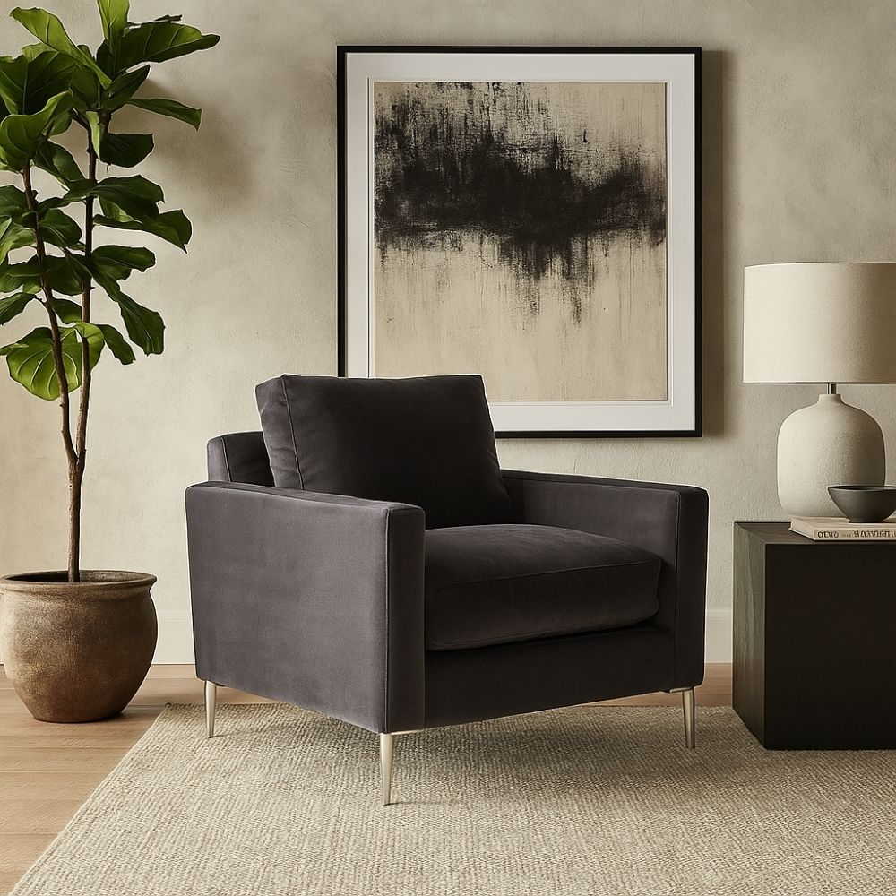 Charcoal velvet accent chair with structured arms, loose back cushion, and slender polished chrome legs.