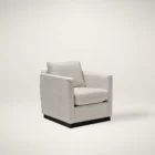 Modern ivory swivel chair with boxy arms, plush cushions, and a sleek black plinth base