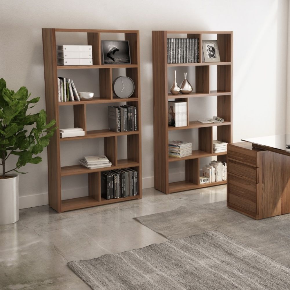 Tall walnut bookcase with asymmetrical open shelving in a modern grid layout