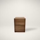 Walnut filing and storage cabinet with three soft-close drawers in a minimalist, modern silhouette