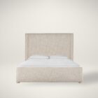 Upholstered bed with a high winged headboard in textured neutral fabric, rounded corners, and low wood feet, shown in both studio and lifestyle settings.