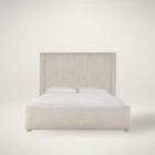 Upholstered bed with a high winged headboard in textured neutral fabric, rounded corners, and low wood feet, shown in both studio and lifestyle settings.