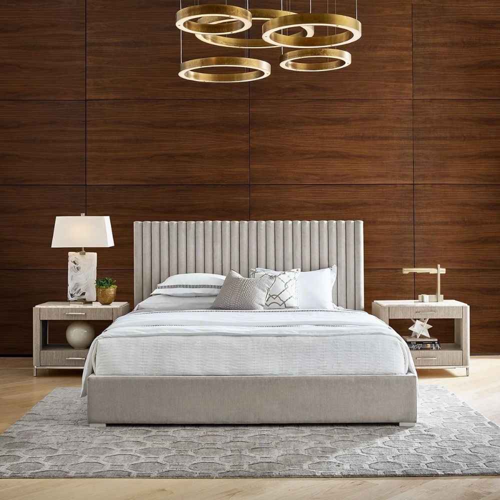 Upholstered bed with vertical channel tufting and minimalist frame.