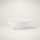 White round cocktail table with a smooth, curved bowl-like silhouette and minimalist matte finish.