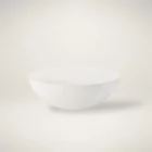 White round cocktail table with a smooth, curved bowl-like silhouette and minimalist matte finish.