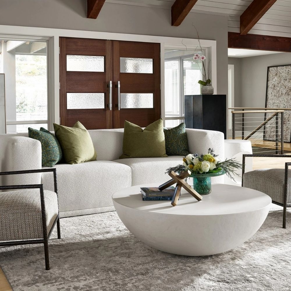 White round cocktail table with a smooth, curved bowl-like silhouette and minimalist matte finish.