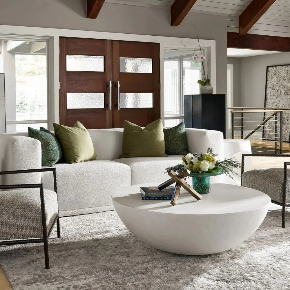 White round cocktail table with a smooth, curved bowl-like silhouette and minimalist matte finish.