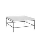 Rectangular white cocktail table with a raised-edge surface and slim black metal frame base.