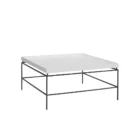 Rectangular white cocktail table with a raised-edge surface and slim black metal frame base.