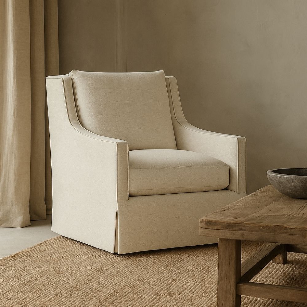 Classic ivory upholstered swivel chair with tailored slipcover and gently sloped arms