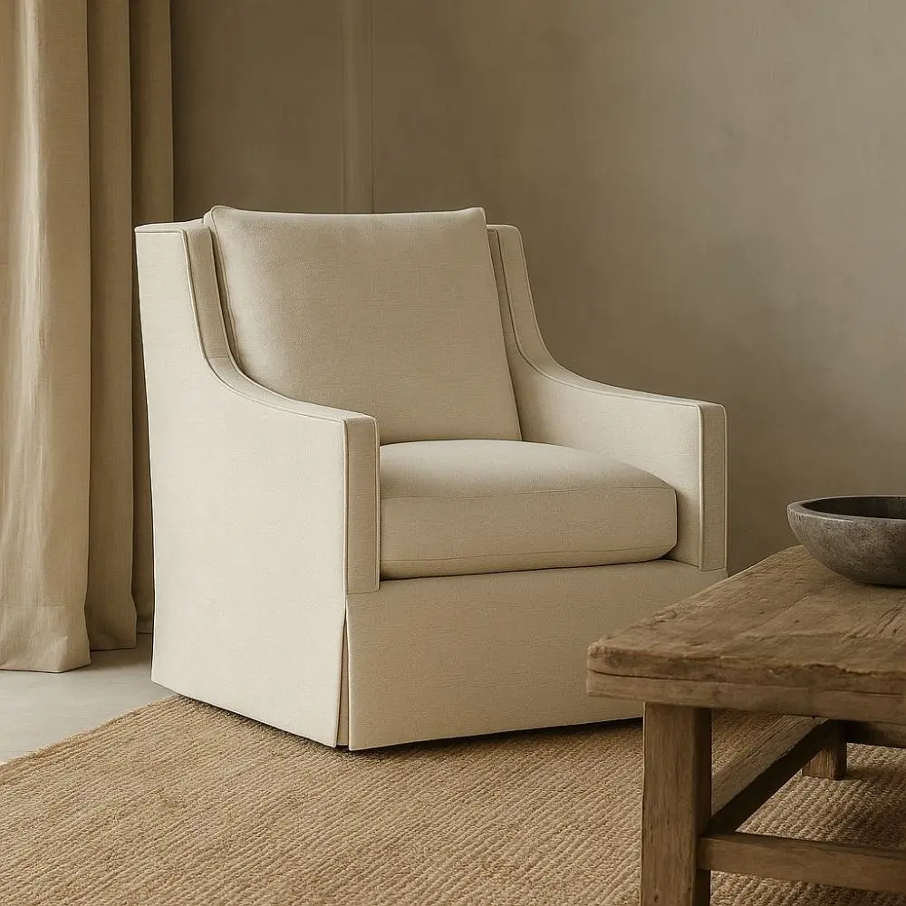 Classic ivory upholstered swivel chair with tailored slipcover and gently sloped arms
