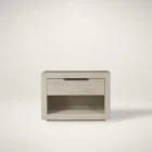 A modern Huston Nightstand featuring a sleek open-frame design with a single drawer and lower shelf in a light wood finish, styled beside a contemporary bed.
